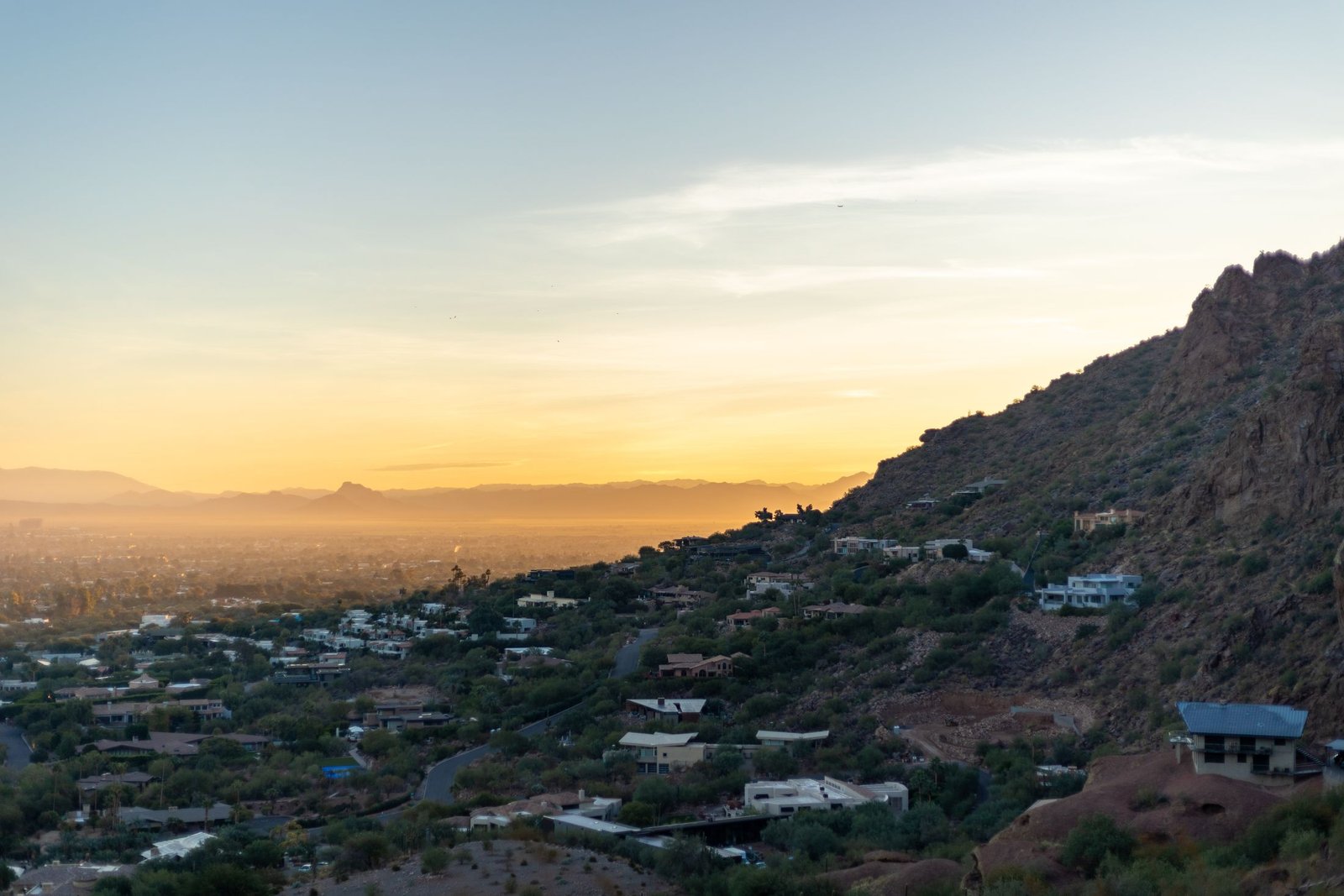 Phoenix hillside homes and desert mountains at sunset