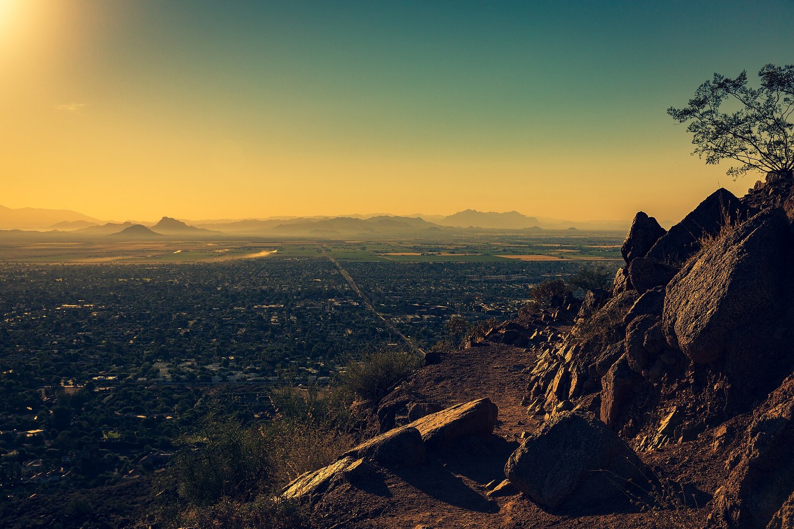 Sunset view across the Phoenix Valley from a desert mountain trail